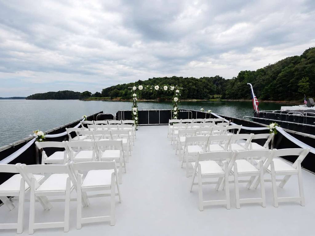 Grass backyard with an unstyled white tent before the event