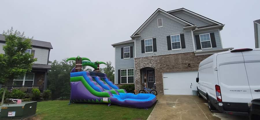 Tall water slide inflatable on a lawn