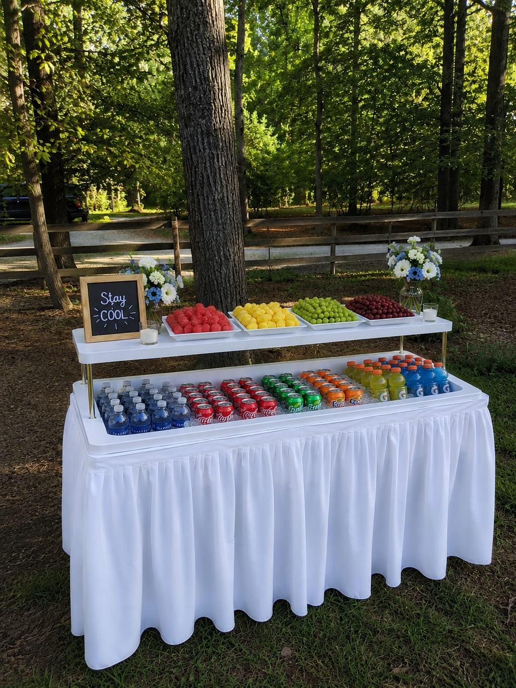 Stay Cool drink station with chilled sodas on a white skirted buffet table